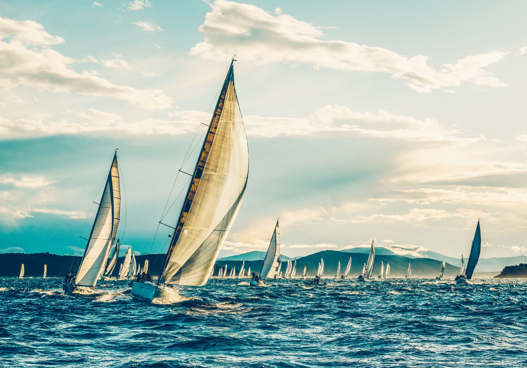 Sailing regatta with sailboats in early morning.